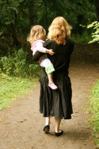 mom-carrying-daughter-facing-away